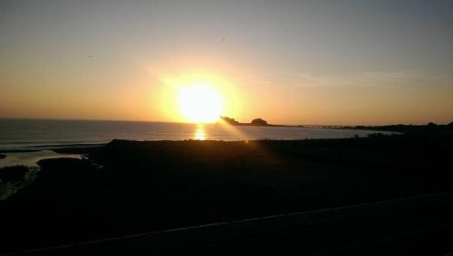 a sunset over the ocean with the sun setting at 三仙台星辰民宿 in Chenggong