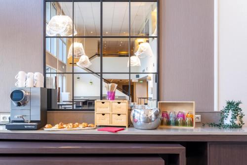 a counter with some food on a table at Mercure Grenoble Centre Porte des Alpes in Grenoble