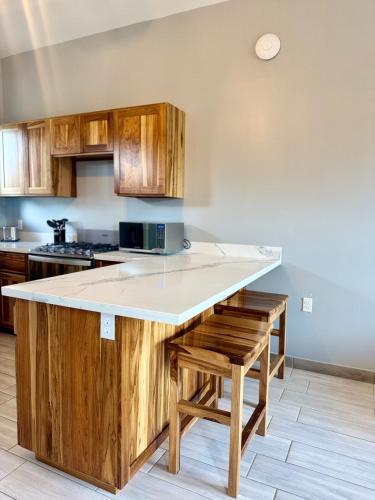 a kitchen with wooden cabinets and a counter top at Quiet Condo-Half Moon Bay Beach in West End