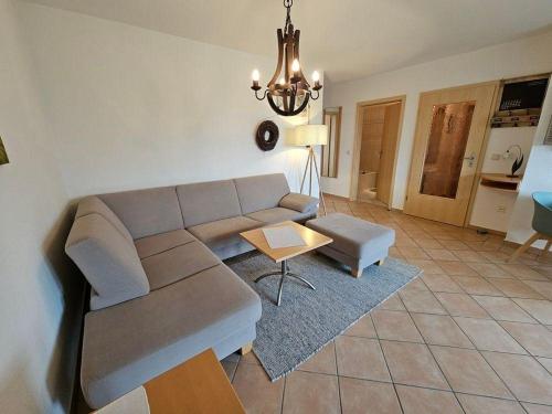 a living room with a couch and a table at Pferdekoppel-im-Haus-zwischen-den-Wassern in Behrensdorf