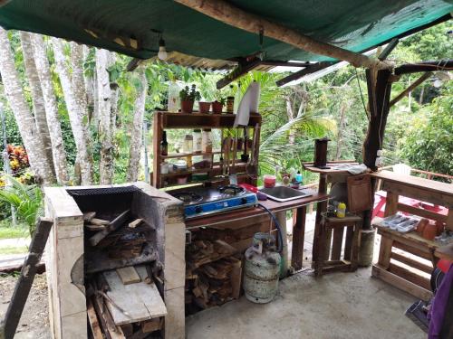 an outdoor kitchen with a stove and a tent at Rancho Napoles in Tapantí