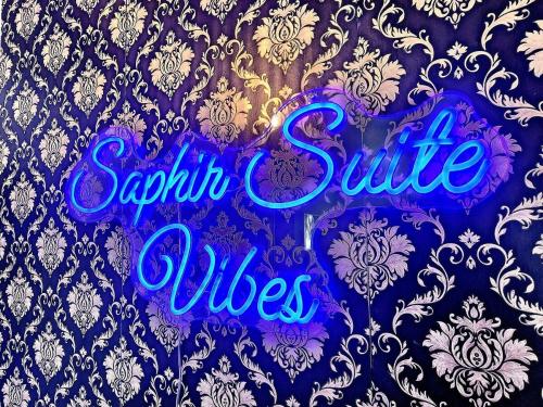 a purple sign that reads sapphire suite villages at Cozy 2BR - 2 King Beds & 2 Parking - 8min to Old Town in Quebec City