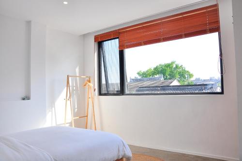 Ένα ή περισσότερα κρεβάτια σε δωμάτιο στο Xingle Hotel-Suzhou Guanqian Street Pingjiang Road