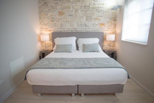 a bedroom with a large bed with two pillows at Agromarino in Sirolo