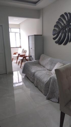 a bedroom with a bed and a living room at Spectacular Agriões Location in Teresópolis