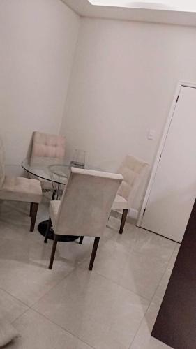a room with a table and a chair and a glass table and chairs at Spectacular Agriões Location in Teresópolis