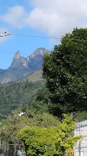 a mountain in the distance with trees in the foreground at Spectacular Agriões Location in Teresópolis