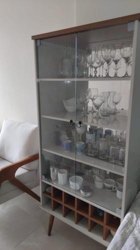 a glass cabinet filled with dishes and glasses at Spectacular Agriões Location in Teresópolis