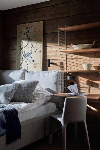a bedroom with a bed and a desk and a chair at Siedlisko Ublik in Wyszowate