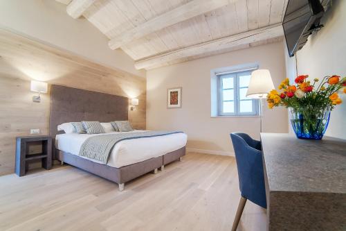 a bedroom with a bed and a vase of flowers at Agromarino in Sirolo