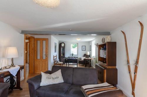 a living room with a couch and a dining room at Ferienhaus Lauwenhaus mit Sauna und eingezäunten Garten in Braunlage