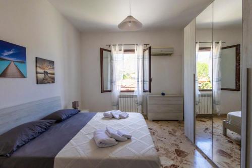 a bedroom with a large bed with towels on it at Casa Cloe Mondello in Palermo