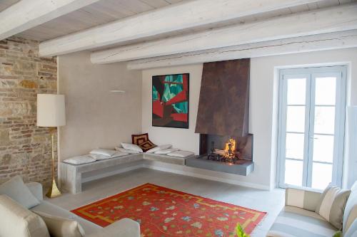a living room with a couch and a fireplace at Agromarino in Sirolo