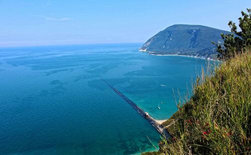 an aerial view of the ocean with a mountain at Agromarino in Sirolo