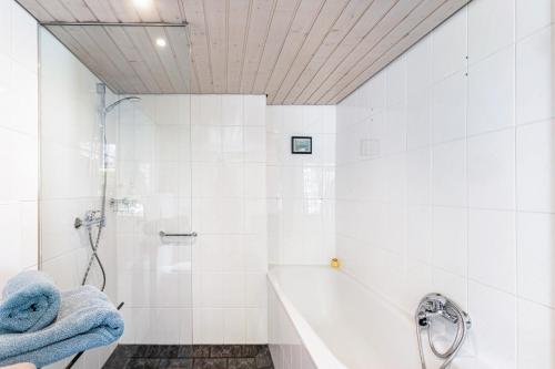 a bathroom with a shower and a bath tub with towels at Fachwerk-Ferienhaus 1764 in Eslohe