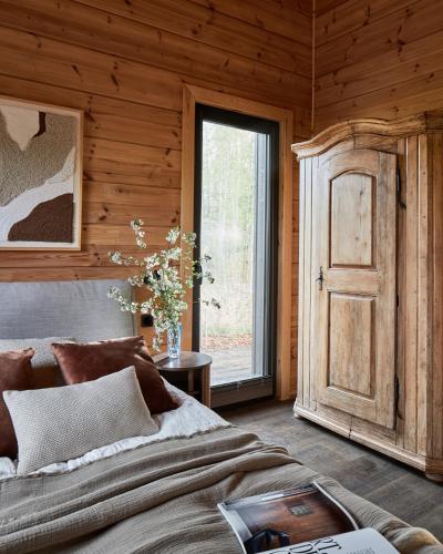 a bedroom with a bed and a window and a door at Siedlisko Ublik in Wyszowate