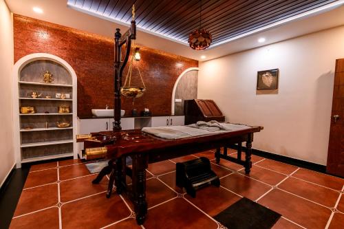 a room with a wooden table in a room at Dr Indulekhas Ayurvedic Wellness & Rejuvenation in Tellicherry