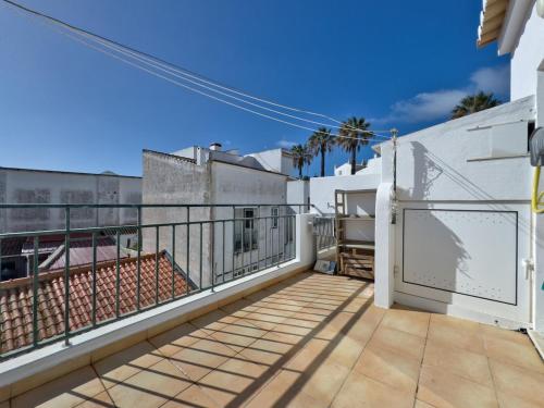 a balcony of a white building with a fence at Room-4-You a 5minutos a pé da praia in Lagos