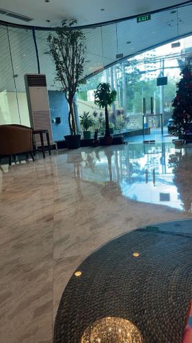 a large lobby with trees in a building at Whole Ocean View Manila Bay 4 Bedrooms in Manila