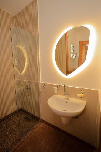 a bathroom with a sink and a mirror at Kaya Nubian House in Aswan