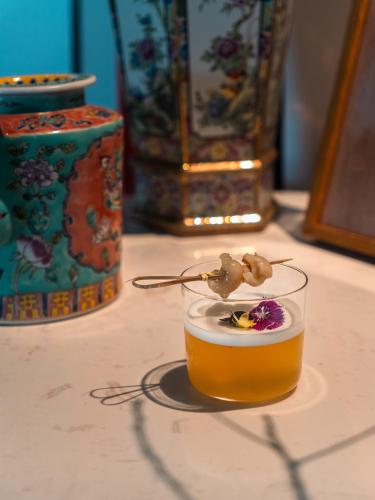 a drink in a glass on a table at Shō Hotel BreakX in Jelutong