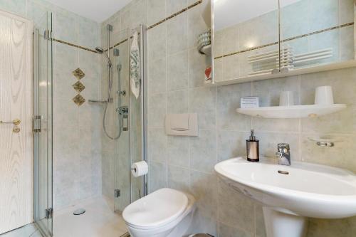 a bathroom with a toilet and a sink and a shower at Gästehaus Gerda in Bad Peterstal-Griesbach