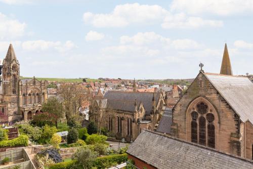 an old church with a view of a city at Newton House - Free Parking in Whitby