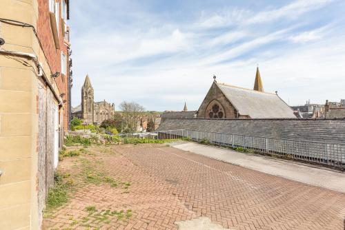 an empty street in front of a church at Newton House - Free Parking in Whitby