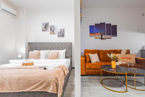 a bedroom with a bed and a couch at Апарт-отель MICH8 by KEYGO in Yerevan