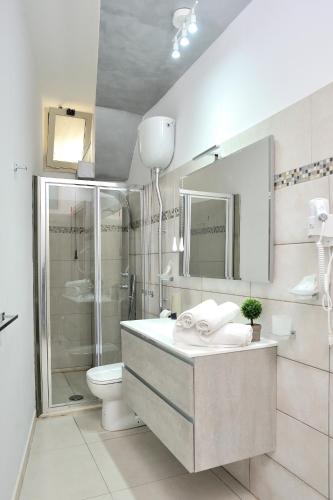 a bathroom with a shower and a toilet and a sink at Elsa cori me in Favara