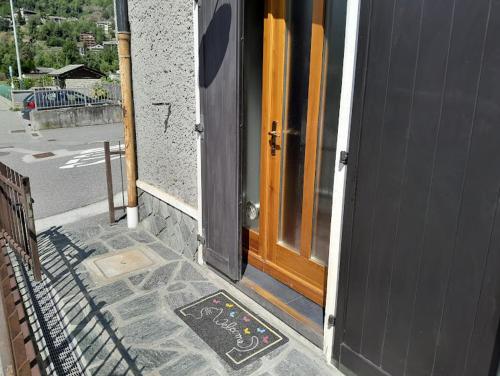 a door of a building with a mat in front of it at Chiesa in Valmalenco Vassalini 1 in Caspoggio