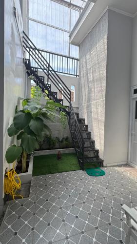 a spiral staircase in a building with a plant at Sultan Agung Homestay Syariah in Magelang