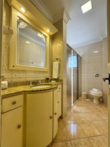 a bathroom with a sink and a toilet at Pousada Serra Valle in Gramado