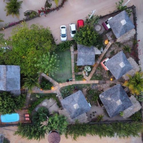 an aerial view of a yard with a car and trees at Caju Bangalôs in Ponta do Anel