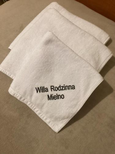 a white napkin with the words milka rochamma melina on it at Willa Rodzinna in Mielno