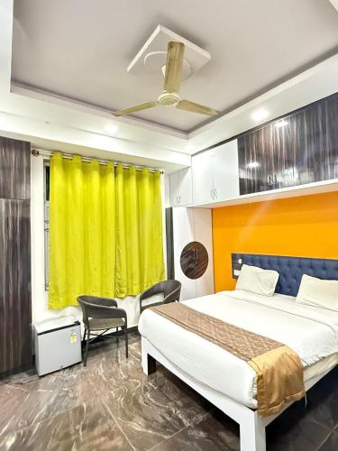 a hotel room with a bed and a yellow curtain at SUPREME SUITs in Jāmb