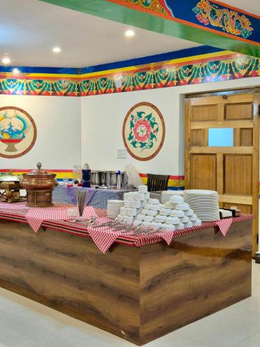 a buffet in a restaurant with a table with dishes at Hotel Palam Hills in Leh