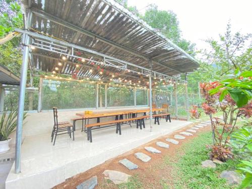 a pavilion with a table and chairs and lights at The Rosa Villa Soc Son in Kon Rung (1)