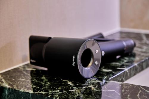 a black flashlight sitting on top of a counter at IoTele南青山 in Tokyo