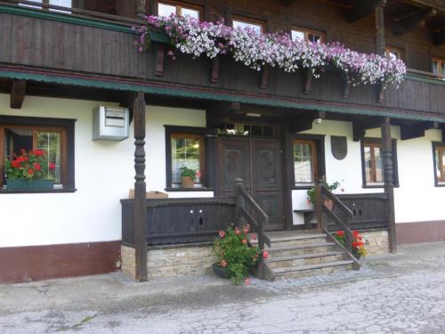 a building with flowers on the side of it at Schwaighof in Oberau