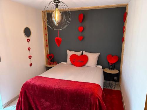 - une chambre avec un oreiller à cœur rouge sur un lit dans l'établissement Love You Suite Romantique Spa 25min du futuroscope, à Oyré