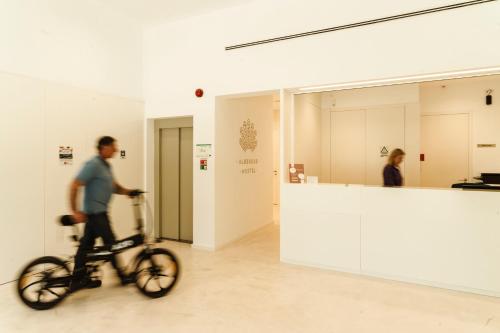 a man is riding a bike in a museum at Albergue de Santa Luzia - Peregrinos de Santiago in Viana do Castelo