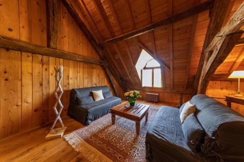 a living room with a couch and a table in a cabin at Château de Mazières in Tendu