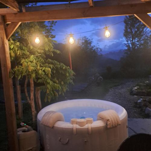 a jacuzzi tub in a gazebo with a view at Gîte Coume a Case, Pyrénées Atlantiques in Lys