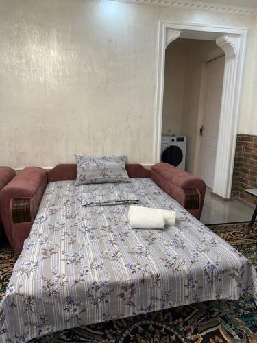 a large bed in a room with a couch at Nugzar House Chakvi - 2 Bedrooms in Chakvi