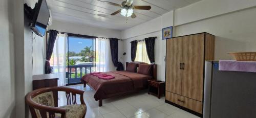 a bedroom with a bed and a window at Rawai Condotel 3 in Rawai Beach