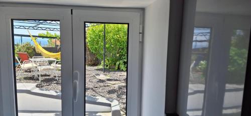 a sliding glass door with a view of a patio at Casa da Ponta in Ponta do Pargo