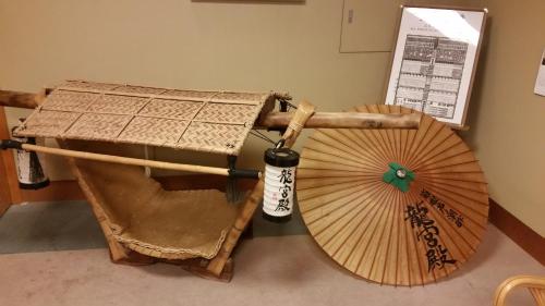two umbrellas sitting on the floor next to a table at Ryuguden in Hakone