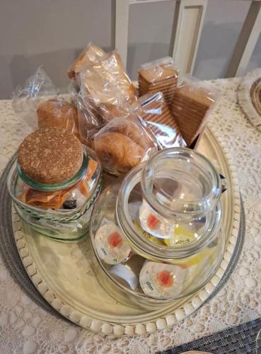 a tray with sandwiches and other food on a table at Armonie di Campagna Rooms & Breakfast di Valentini Sabina in Calderara di Reno