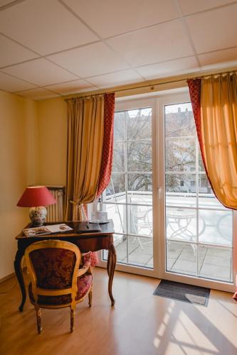 an office with a desk and a large window at Hotel Stadtresidenz in Hildesheim